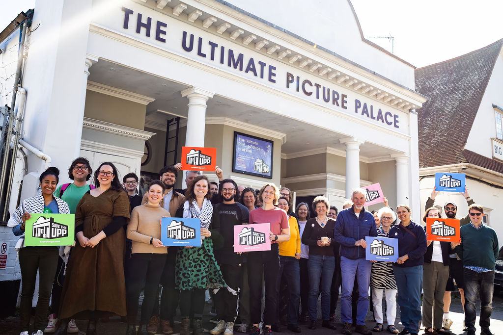 Carla Denyer MP and local Green Party councillors join volunteers outside of the cinema and raise Save the UPP banners.